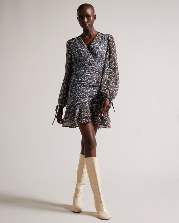 CHERELA-Dresses-It might be downright impossible to not look amazing in CHERELA. With its dropped waist and ruching on the front, pair with a sleek up-do and you're good to go.The fabric of this product is made of 100% recycled polyester. Using recycled polyester helps divert plastic waste from ending in landfills, and helps us to reduce our dependence on virgin materials. Mini dress Long sleeved V-neck Ruched front Ditsy floral print Dropped waist Awuoi is 5'10.5" / 1.79m and wears Light Blue in a Ted size